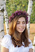 Young woman wearing wreath of heather and sea lavender