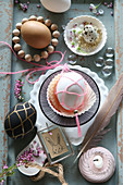 Easter egg in macrame net and vintage-style arrangement of knick-knacks