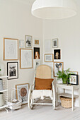 Comfortable rocking chair and gallery of pictures in corner of bright room