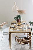 Set table and various chairs in beige dining room