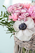 Bouquet of carnations and anemone in basket