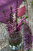 A small bouquet of budding heather in a jar