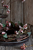 Wreath of Bodnant viburnum twigs and ivy tendrils on tray