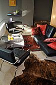Black leather sofa and leather armchair in masculine living room