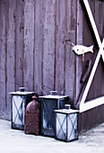Frosty lanterns outside wooden house in winter