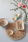 A placemat and a wicker basket decorated with wool