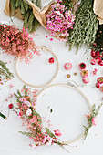 Ingredients for a spring wreath: wooden hoops and dried flowers