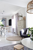 View from living room into bright dining room decorated in white and grey
