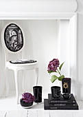 Baroque chair, black books and hydrangeas in vases