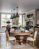 Spacious kitchen diner with limestone floor tiles and bespoke kitchen units