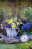 Spring bouquet of narcissus, primulas, cornelian cherry and snowdrops