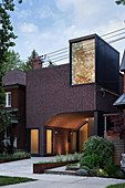 Modern brick house with integrated carport at twilight