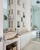 Stucco bathroom with recessed shelving in shower cubicle