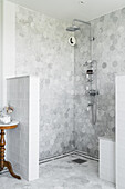 Shower area with marble tiles