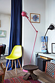 Stool, yellow classic chair, low sideboard and lamps in room with white walls
