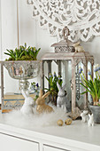 Easter arrangement of grape hyacinths, Easter bunny and wreath of feathers