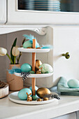 Blue and gold Easter eggs on cake stand