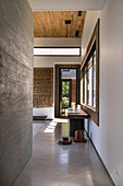 Hallway in modern, architect-designed house with concrete walls and floor
