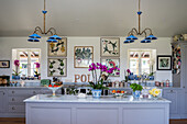 Blue ceiling lights above island counter in classic kitchen