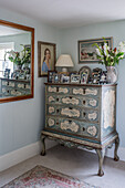 Antique chest of drawers with vintage-style decor in bedroom