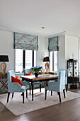 Elegant chairs with blue-grey upholstery in dining area