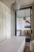 Elegant dressing room and view into the bathroom with picture of flamingo