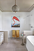 Picture of flamingo on white-tiled wall in bathroom