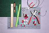 Materials for making tiny colourful Christmas wreaths from felt squares