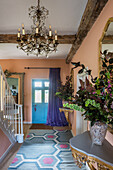 Hallway with blue front door and salmon-pink walls