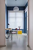 View into study with blue walls and white window blinds