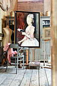 Painted portrait of woman and vintage accessories in artist's studio