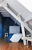 Attic bedroom with white ceiling beams, sloping ceiling and grey walls