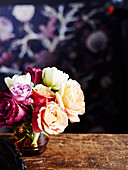 Bouquet of roses on vintage wooden table