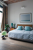 Doppelbett, darüber Bild und Retro Dekoobjekte im Schlafzimmer