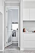 Open door in white modern kitchen