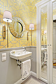 Yellow wallpaper with graphic pattern in small, elegant bathroom