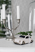 Model car with juniper branch and candlesticks