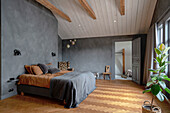 Bedroom with herringbone parquet flooring, grey walls and high ceiling
