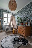Slide car in the children's room in vintage style with antique chest of drawers