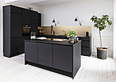 Modern black kitchen with golden splashback