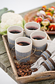 Four cups of mulled wine on a wooden tray