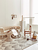 Sofa, beaded stool, mirror with vintage papier-mâché frame, chair and vase on carpet