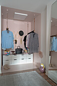 Open wardrobe with clothes rails and cabinets