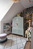 Grey wardrobe, giraffe figure and seat cushion in the children's room on the top floor