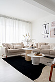 Bright living room with coffee tables and beige sofa set