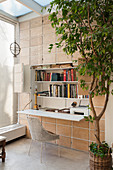 Fold-out desk with shelving in conservatory with terracotta wall tiles