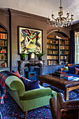 Modern artwork above marble fireplace with recessed bookcases in 18th century mansion