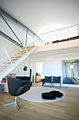 Open-plan interior with stairs leading to gallery in loft apartment