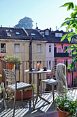 Bistro table with two chairs on the balcony, view of the neighboring building