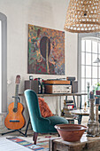 Vintage furnishings in living room, guitar next to console with a record player